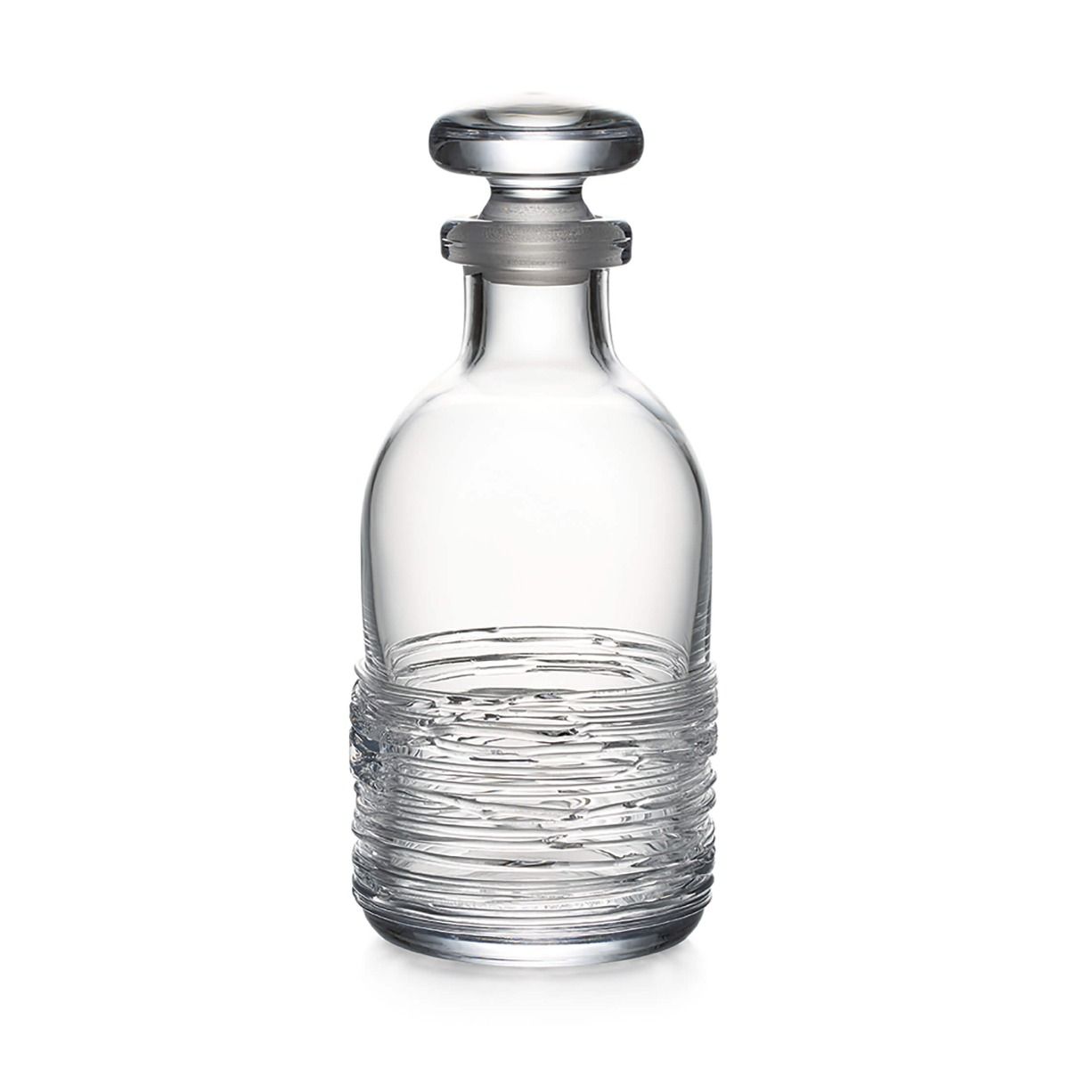 The Echo Lake Decanter by Simon Pearce features textured horizontal lines and a round stopper, expertly crafted by master glassblowers. Shown here in clear glass against a white background.