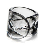 The Simon Pearce Ascutney Napkin Ring features thick, clear handmade glass with a twisted sculptural design, shown on a white background—ideal for adding a unique touch to your table setting.