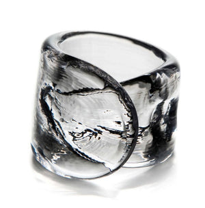 The Simon Pearce Ascutney Napkin Ring features thick, clear handmade glass with a twisted sculptural design, shown on a white background—ideal for adding a unique touch to your table setting.