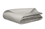 A neatly folded Alba Bedding Collection blanket in silver by Matouk, featuring a light gray textured Egyptian cotton design, is displayed on a white background.