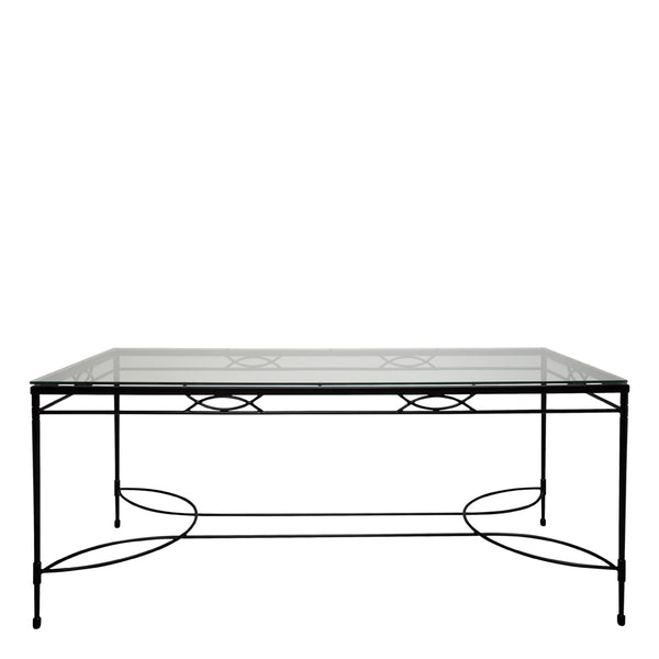A black metal-framed Amalfi Dining Table with a glass top and a lower slate shelf by Janus et Cie, isolated on a white background.