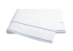 A folded white bedsheet from the Matouk Ansonia Bedding Collection, Ocean, features a light blue stripe near the edge and is made from premium 500 thread count cotton percale, displayed on a plain background.