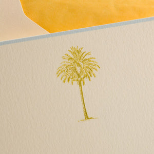 The Palm Tree Card Set by Printery features a textured white vertical ecru card with a simple chartreuse palm tree near the bottom and a yellow envelope peeking out behind it.