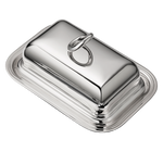 The Christofle Vertigo Butter Dish, with a rectangular silver-plated design and rounded lid and handle, sits on a matching tray in this photo against a white background.