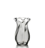 The Chelsea Small Optic Vase by Simon Pearce is a handmade glass piece with a clear, twisted body and ruffled rim, beautifully displayed upright on a white background.