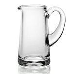 The William Yeoward Crystal Clear Classic Cream Jug is a handmade glass pitcher with a wide base, narrow spout, and large curved handle, ideal for serving berries and cream. Shown here against a plain white background.