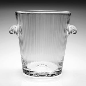 The Corinne Champagne Bucket by William Yeoward Crystal features handmade glass with vertical ribbed texture and two rounded side handles, perfect for elegant celebrations. Set against a neutral background. Proposition 65 warning applies.