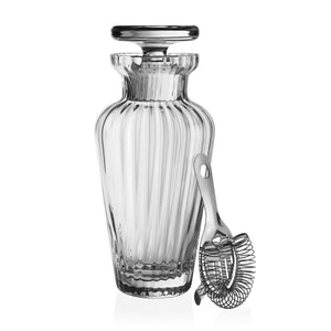 The William Yeoward Crystal Corinne Cocktail Shaker & Strainer features clear, ribbed handmade glass and a stainless steel strainer. Proposition 65 warning: This product may expose you to chemicals known to cause harm in California.