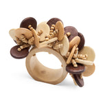The Coin Beads Napkin Ring Set by Deborah Rhodes features chunky wooden rings adorned with clusters of round, flat discs and coiled accents in light and dark brown tones—an elegant touch for any table setting.