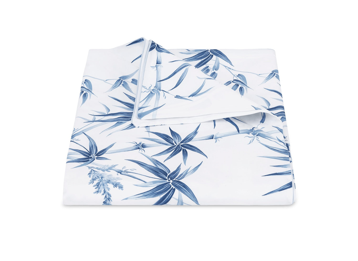 The Dominique Bedding Collection, Azure by Matouk features a folded white Egyptian cotton sheet with a bold blue botanical pattern, displayed on a plain white background.