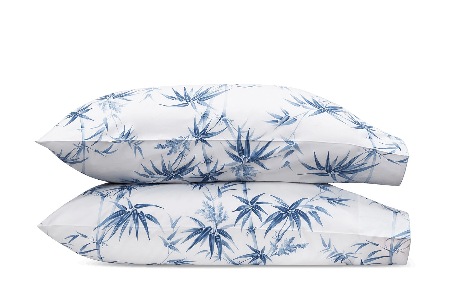 A set of two Matouk Dominique Azure pillows with Schumacher’s Arita floral print on a white background.