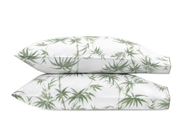 Two white pillows from the Matouk Dominique Bedding Collection, Palm, feature a green leafy botanical pattern and are crafted from luxurious Egyptian cotton, OEKO-TEX Standard 100 certified for comfort.