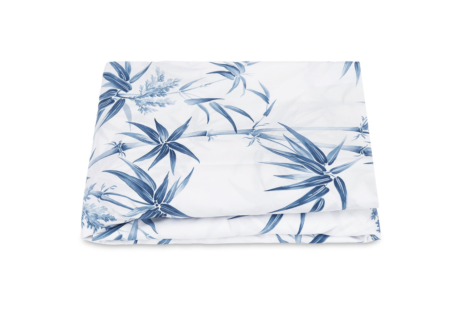 The Dominique Bedding Collection, Azure by Matouk features a folded white bedsheet with a bold blue botanical leaf pattern, made from soft Egyptian cotton and displayed on a plain white background.