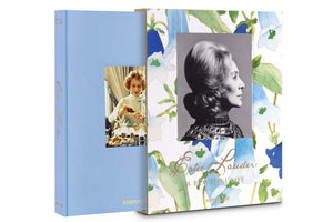 Two books about Estée Lauder: 'Estée Lauder: A Beautiful Life' from Assouline, featuring a sepia-tone portrait against a floral backdrop and another showcasing a photograph of her working on her cosmetics empire, all presented in an elegant personal album.