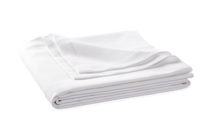 The Elliot Bedding Collection in White by Matouk features a neatly folded diamond pique textured blanket on a flat surface—a modern bedroom staple that’s OEKO-TEX® Standard 100 certified.
