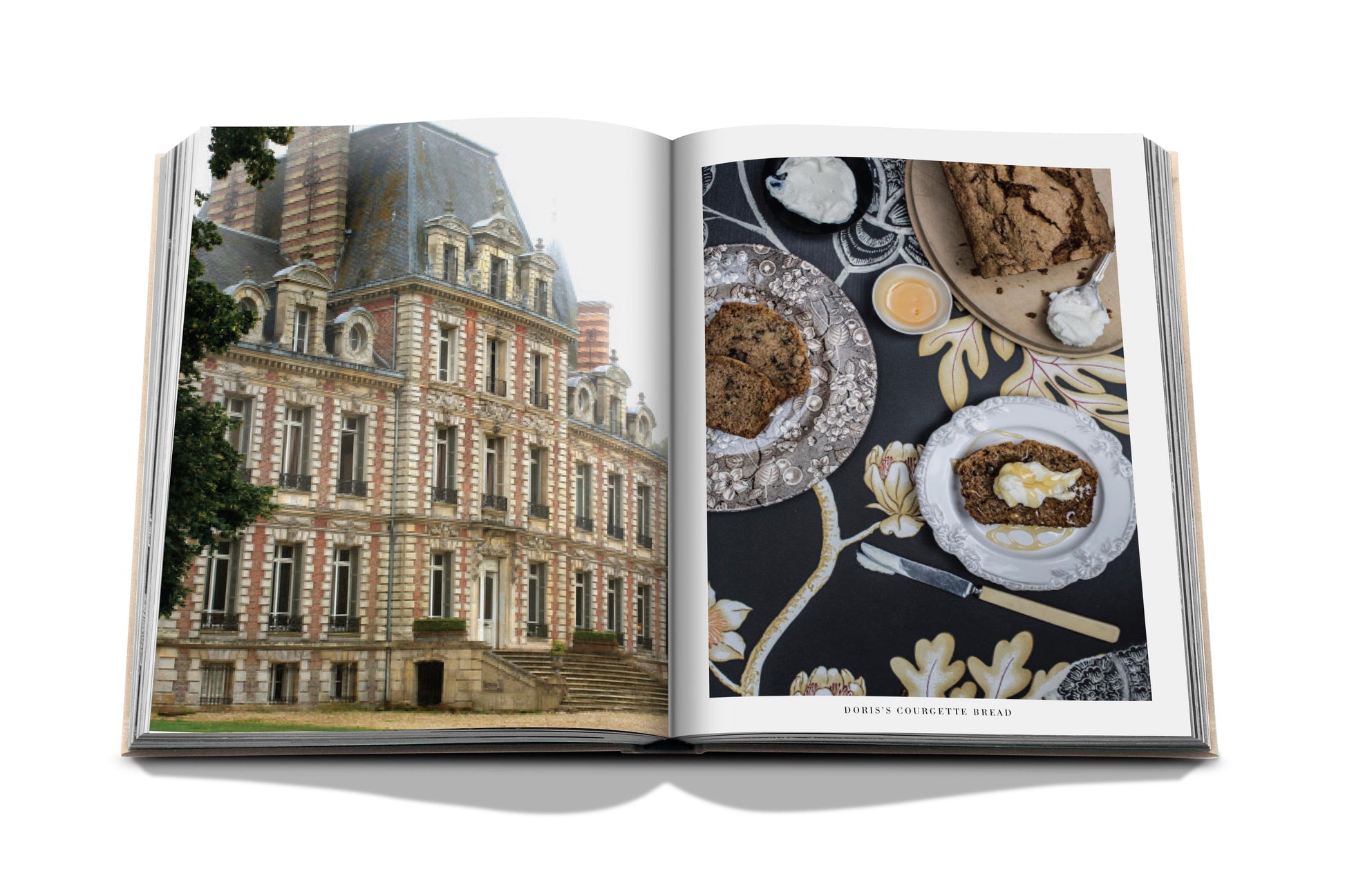 An open book displays a photograph of the historic Château Bosgouet on the left page, while various plated dishes inspired by French recipes adorn the right page in "Chateau Life" by Assouline.