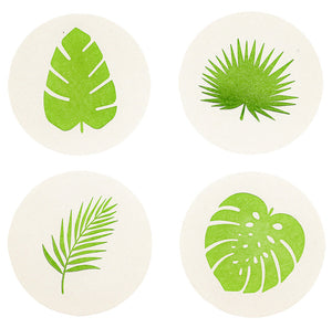 The Monstera Leaf Coasters by Haute Papier include four round, letterpressed coasters, each with a unique green monstera leaf design on white—perfect as a hostess gift.