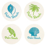 Set of four Palm Beach Coasters by Haute Papier, each round and letterpressed with "Palm Beach" text plus unique blue and green designs: conch shell, palm tree, parrot, and scallop shell. A chic hostess gift.
