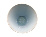 The Vuelta Ocean Blue Serving Bowl by Jars features a top view of smooth blue gradient ceramic with iridescent glaze and an intricate circular center pattern, shown against a white background.