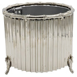 The Small Nickel Corrugated Bamboo Cachepot by Global Views is a handmade, metallic cylindrical piece with vertical ridges, bamboo-inspired edges, and four petite feet.