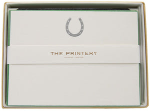 The Printery Horseshoe Card Set includes silver horseshoe cards with a green square corner on the top card, paired with black tissue envelopes and finished with a branded band.