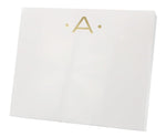 The Gold Initial Large Notepad by Black Ink features a white rectangular box with a gold letter "A" and two gold dots on the front, crafted from high-quality heavy weight paper.
