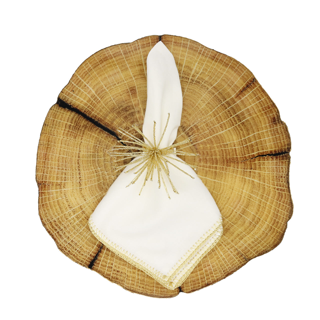 A white cloth napkin with gold trim and a decorative ring rests on the Kim Seybert Woodland Placemat, showcasing country charm—perfect for a nature-inspired luncheon or rustic tablescape.