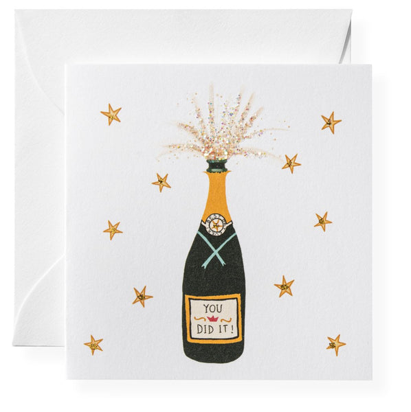 A Karen Adams greeting card featuring an illustrated popping champagne bottle with champagne glasses and the phrase "you did it!" surrounded by stars.