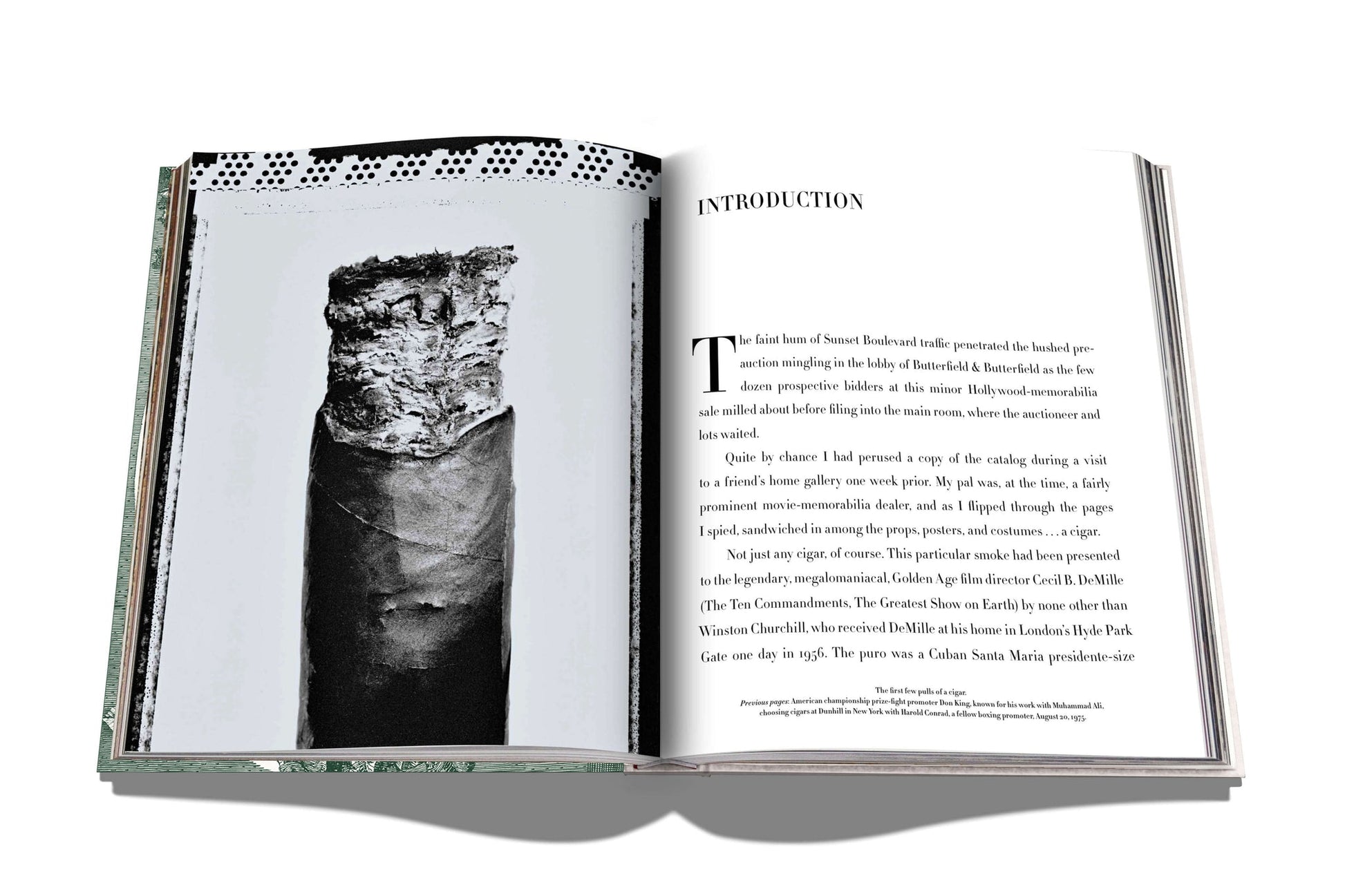 An open book from Assouline’s "The Impossible Collection of Cigars" showcases an introduction on the right and a black-and-white photo of a prestigious cigar on the left, part of an exclusive collection.