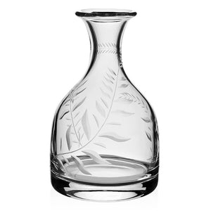 The Jasmine Classic Carafe Bottle by William Yeoward Crystal features a wide base, narrow neck, and hand-engraved Jasmine Vine motif on clear glass.