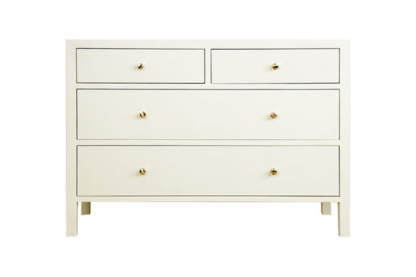 The Made Goods Jarin Dresser is a designer white chest of drawers with brass handles, offering ample storage.