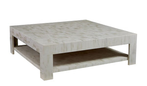 The Sherrill/Mr & Mrs Howard Matterhorn Faux Horn Cocktail Table is a square, light-colored wooden coffee table with a bone finish and lower shelf, featuring a simple, minimalist design that's perfect for enhancing your home decor.