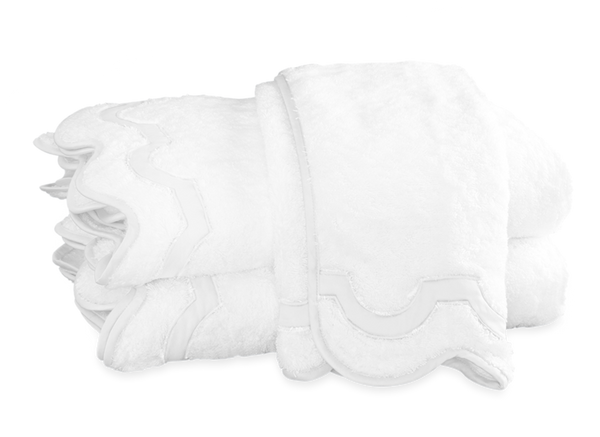 Four Matouk Mirasol Bath Collection - Bone towels stacked on top of each other.