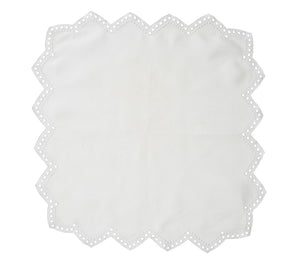 The Kim Seybert Eyelet Tapestry Napkin Set features white linen napkins with scalloped eyelet borders and small circular cutouts, shown on a plain background.