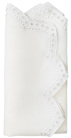 The Kim Seybert Eyelet Tapestry Napkin Set features folded white linen napkins with embroidered eyelet accents and delicate chevron-cut edges.