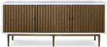 The Naples Cabinet by Mr Brown is a modern wooden sideboard with a smooth white gesso top, four vertically ribbed doors in aged brass, and slender legs.