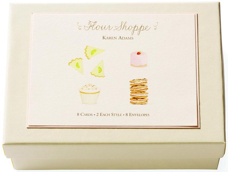 The Flour Shoppe Card Set by Karen Adams features a cream-colored box with hand-embellished dessert art, containing 8 note cards (4 styles) and 8 envelopes—an ideal hostess gift.