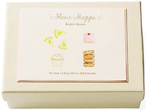 The Flour Shoppe Card Set by Karen Adams features a cream-colored box with hand-embellished dessert art, containing 8 note cards (4 styles) and 8 envelopes—an ideal hostess gift.