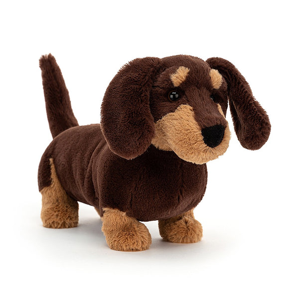 A dark chocolate fur dachshund stuffed animal named Jellycat Otto Sausage Dog, Large on a white background.