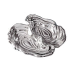 The Beatriz Ball Ocean Oyster Double Dip is a clear glass dish with an abstract organic shape, featuring two sections and a glossy finish, inspired by handmade artistry.