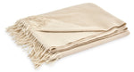 Displayed against a white background, the Matouk Paley Cashmere Throw by Matouk is an oversized beige throw adorned with fringe edges.