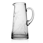 The Palmyra Pitcher by William Yeoward Crystal features a handle and etched palm trees, shown against a white background—a stylish addition to any table setting.