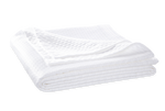 The Matouk White Pearl Bedding Collection features a neatly folded, quilted matelassé blanket made from luxurious Egyptian cotton, sitting against a plain background.