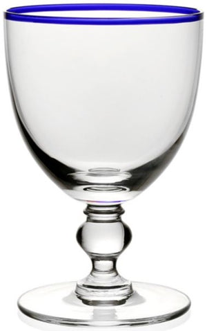 The Blue Siena Water Glass by William Yeoward Crystal is a clear handmade glass with a short stem, round base, and thin blue rim. Proposition 65 warning applies.