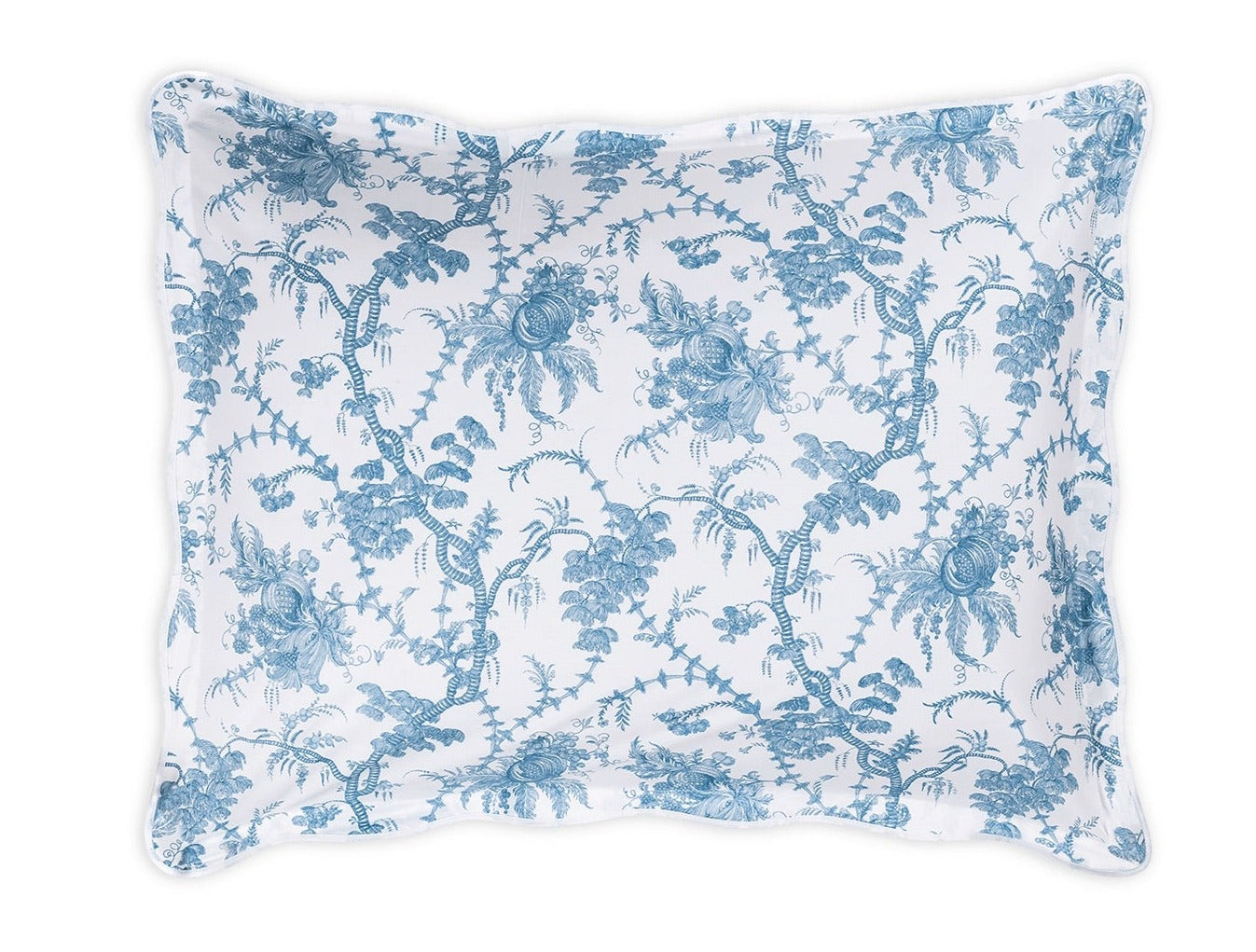 A rectangular pillow from Matouk’s San Cristobal Bedding Collection, Sky, features scalloped edges, Luca Egyptian cotton percale, and Schumacher’s blue floral and vine pattern on a white background.