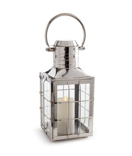 An Nantucket Nickel Outdoor Lantern, Large by Napa Home & Garden, with maritime shapes and an upscale touch, housing a candle inside.