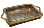 The Calaisio Rectangular Baker with Pyrex Insert features a glass baking dish nestled in a handmade water-vine wicker tray with handles, expertly crafted by artisans.
