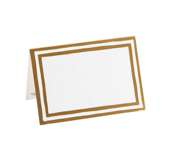 A white and gold die-cut Caspari - Border Stripe Gold Place Cards for tabletop décor.