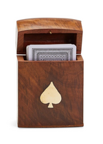 Two's Company's Acacia Wood Crafted Box with Playing Cards features a brass spade emblem and opens to display a deck of playing cards, highlighting its decorative inlay and elegant design for ideal card storage.