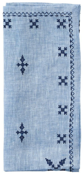A Kim Seybert Fez Napkin in Periwinkle, Set of 4 featuring decorative Moroccan embroidery and zigzag edge details.